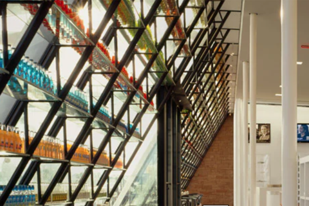 Racks of colorful sodas near a window.
